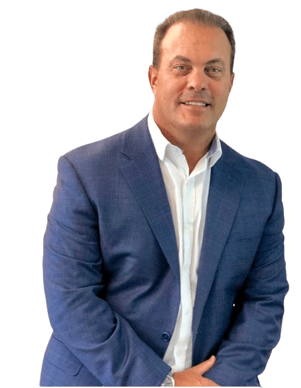 A man in a dark blue blazer over a white shirt stands confidently with his arms crossed, against a black background.