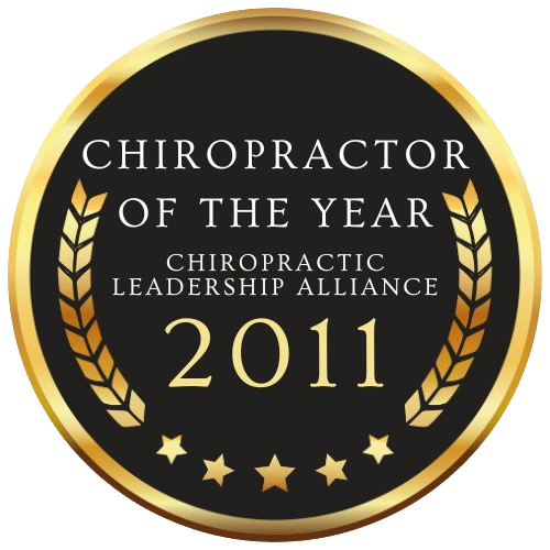 Gold and black badge with the text 'Chiropractor of the Year - Chiropractic Leadership Alliance 2011,' featuring laurel wreaths and stars.